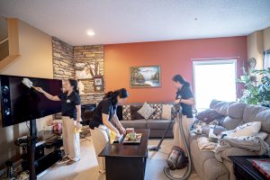 3 cleaning ladies cleaning a room together